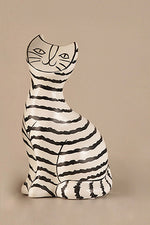Hand-drawn ceramic cat sculpture with black stripes in Scandinavian minimalist style