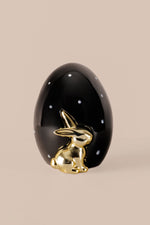 Ceramic egg ornament with black finish white polka dots and gold bunny decor