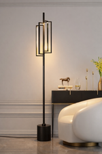 Modern floor lamp in a stylish room with a sofa and decorative items.