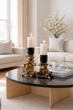 Decorative candle holders on a coffee table in a living room setting