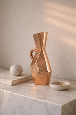 Geometric wooden vase on a marble surface with a neutral background