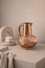 Wooden geometric pitcher on a neutral surface with a soft background