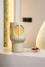 Ceramic lamp with textured design on a white surface