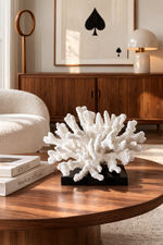 White coral sculpture on a wooden table with a modern interior background