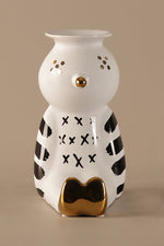 Ceramic clown shaped vase with black patterns and gold accents