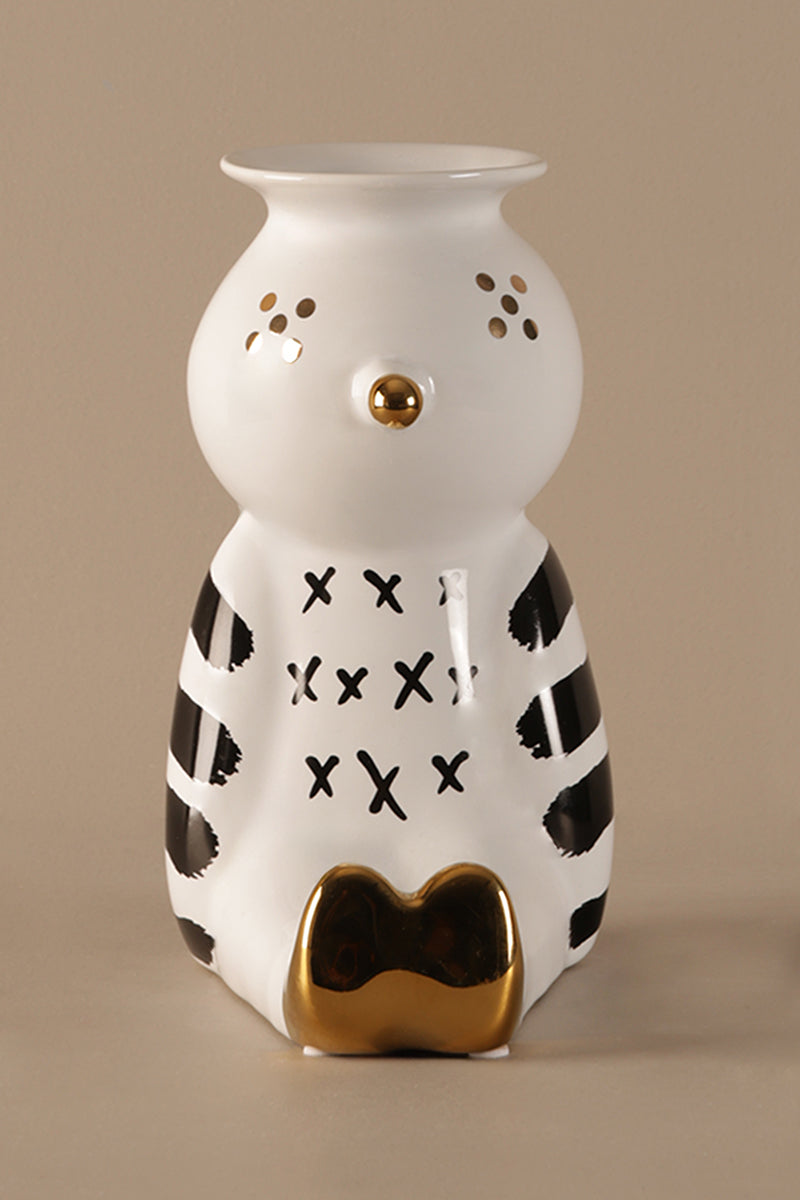 Ceramic clown shaped vase with black patterns and gold accents