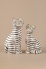 Hand-drawn ceramic cat sculpture with black stripes in Scandinavian minimalist style