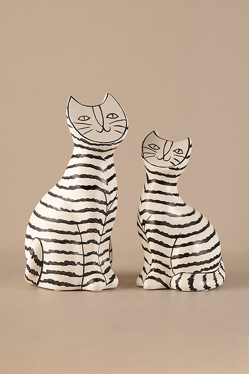 Hand-drawn ceramic cat sculpture with black stripes in Scandinavian minimalist style