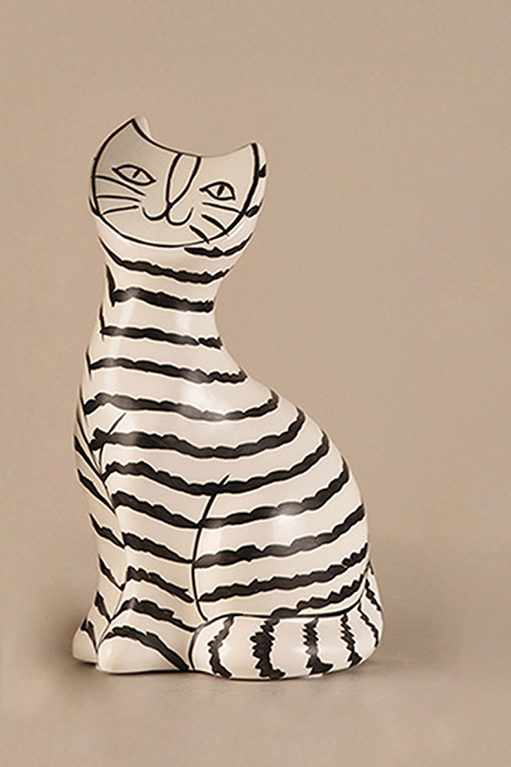 Hand-drawn ceramic cat sculpture with black stripes in Scandinavian minimalist style