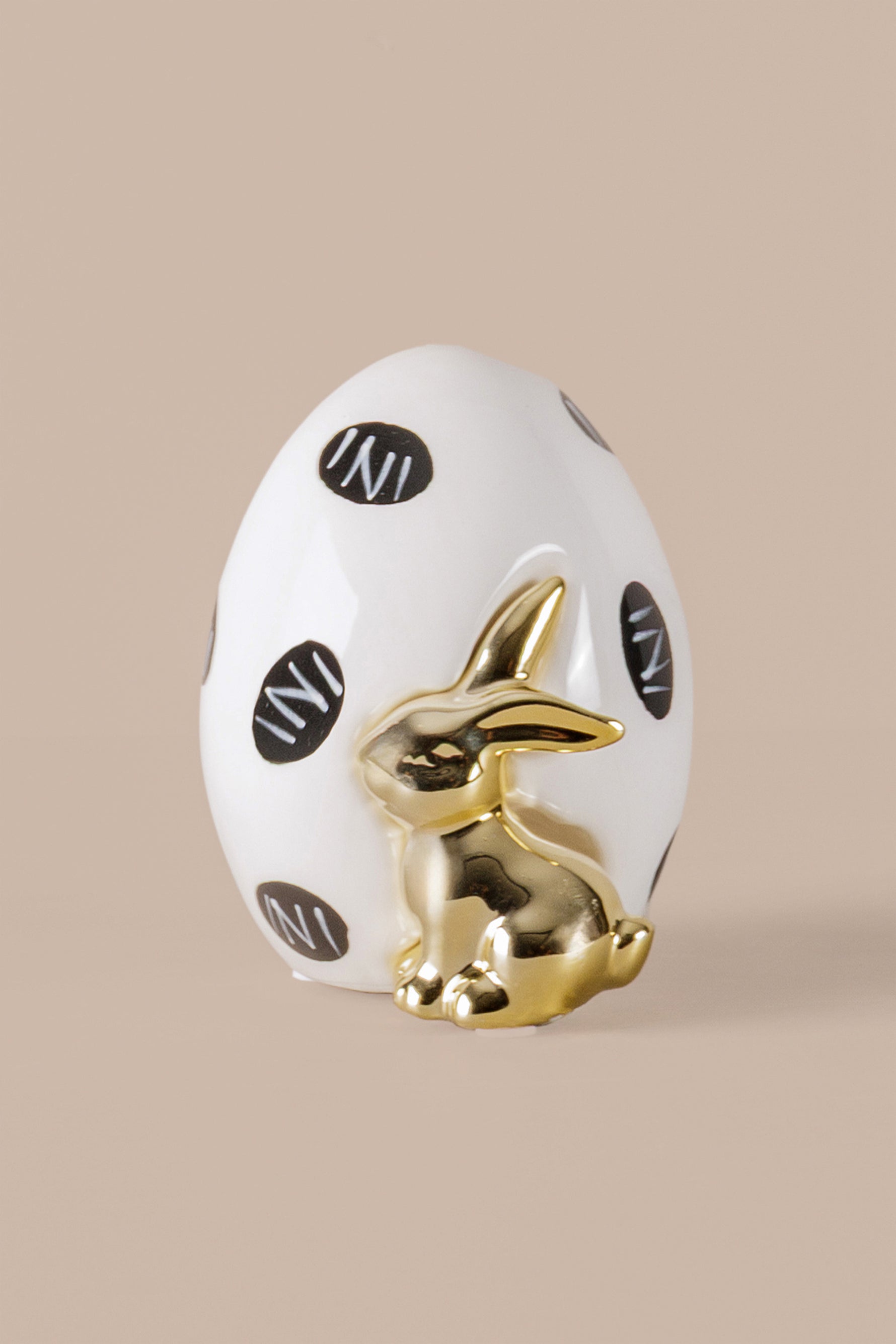 Ceramic egg ornament with white finish black dots and gold rabbit decor