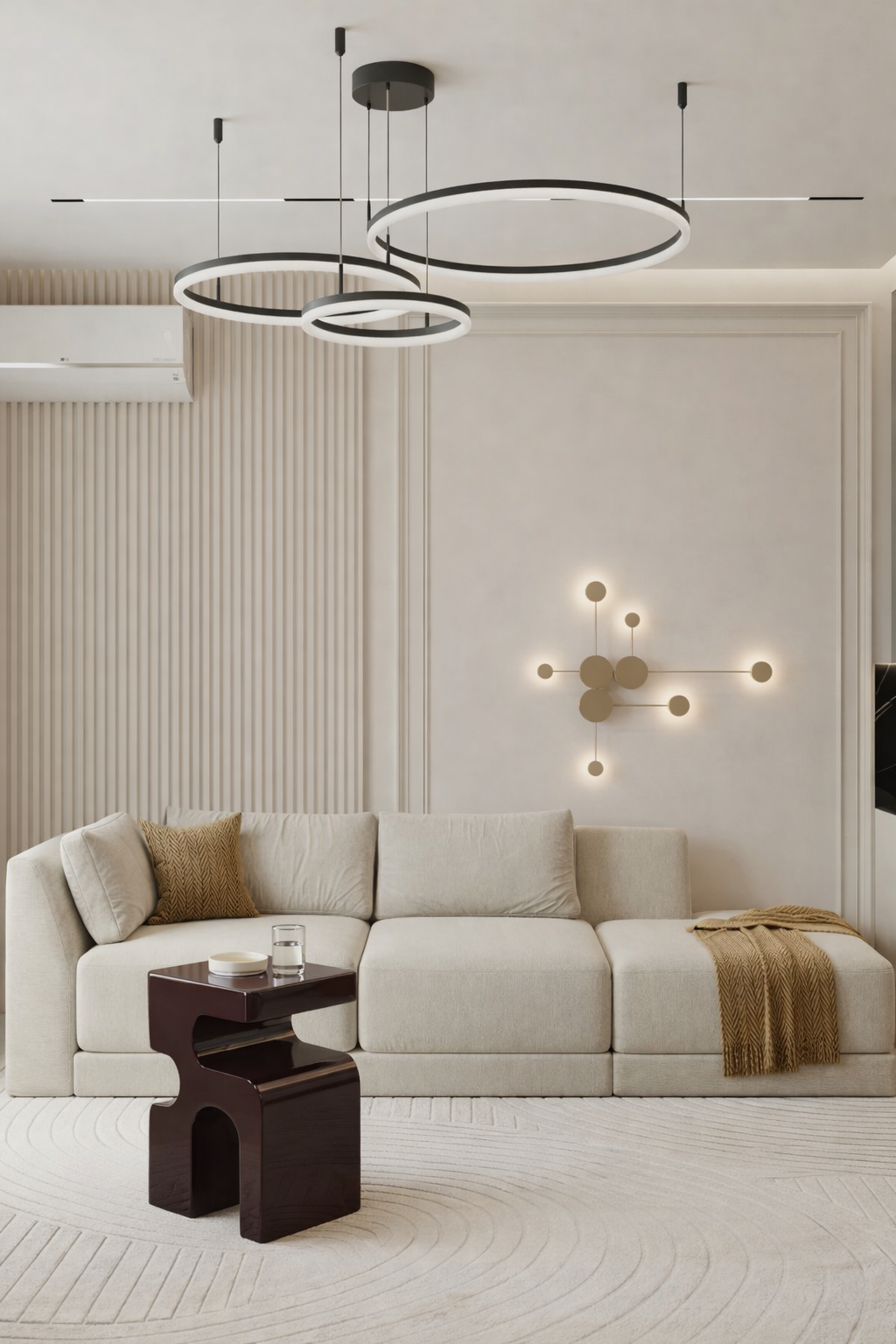 Modern living room with a sectional sofa, coffee table, and decorative wall lights.