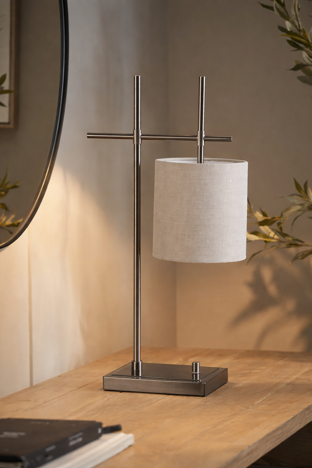 Table lamp with a beige shade on a wooden surface, with a blurred background