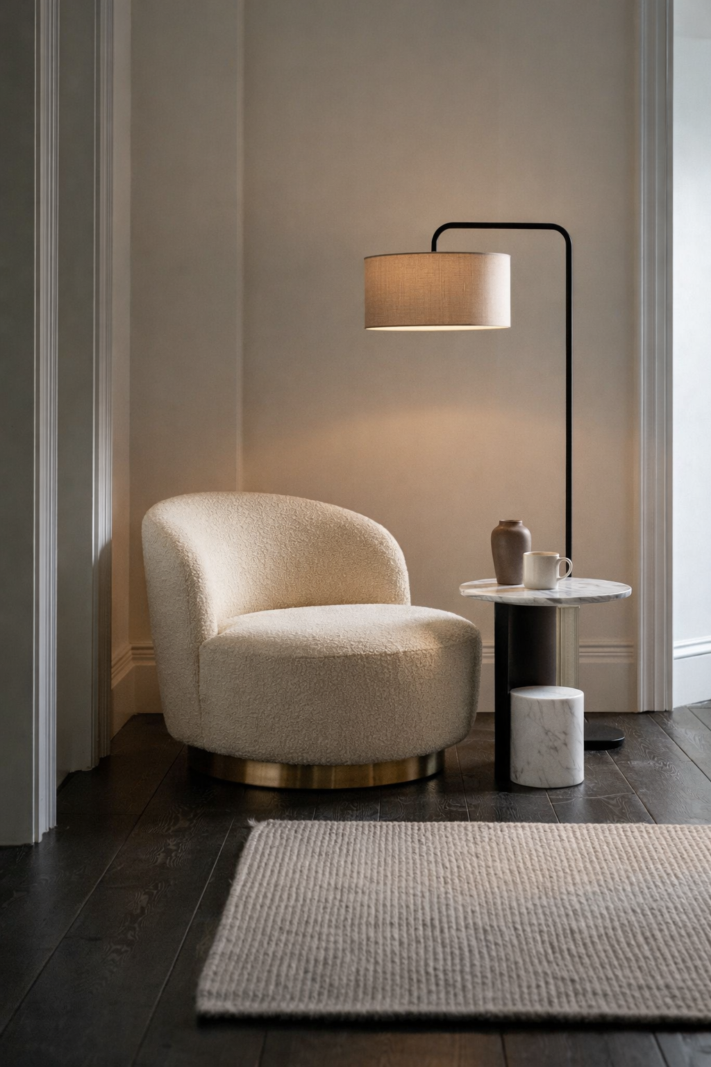 Modern interior with a beige armchair, floor lamp, and side table.