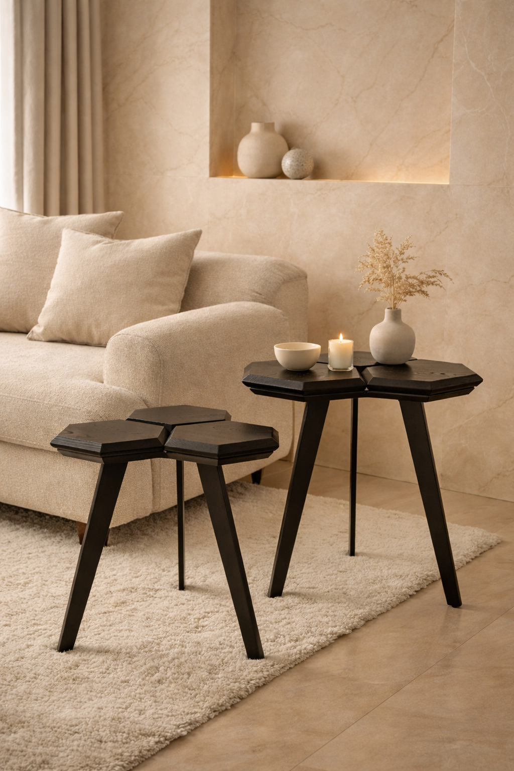 Modern living room with beige sofa, black side table, and decorative items.