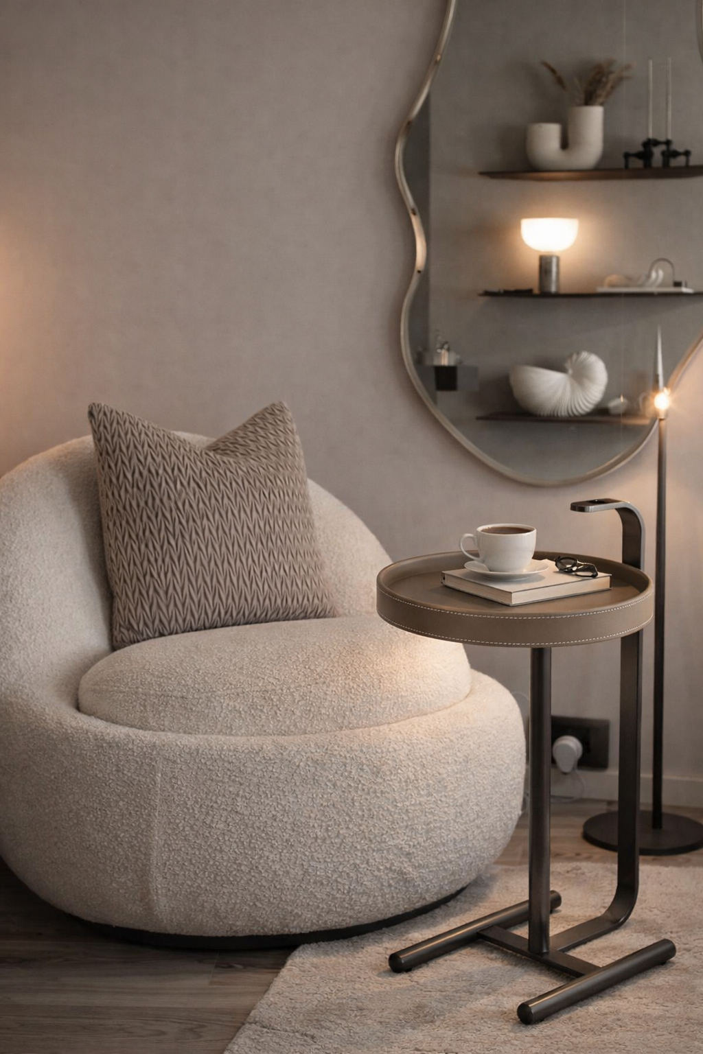 Modern living room with a round beige chair, side table, and decorative items.