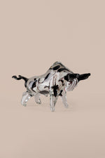 Mirror finish bull sculpture showing polished chrome metallic surface