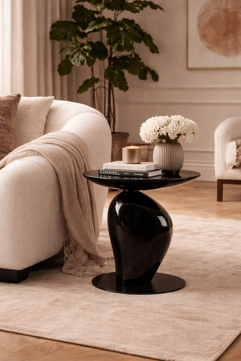 Modern living room with a black side table, beige sofa, and decorative elements.