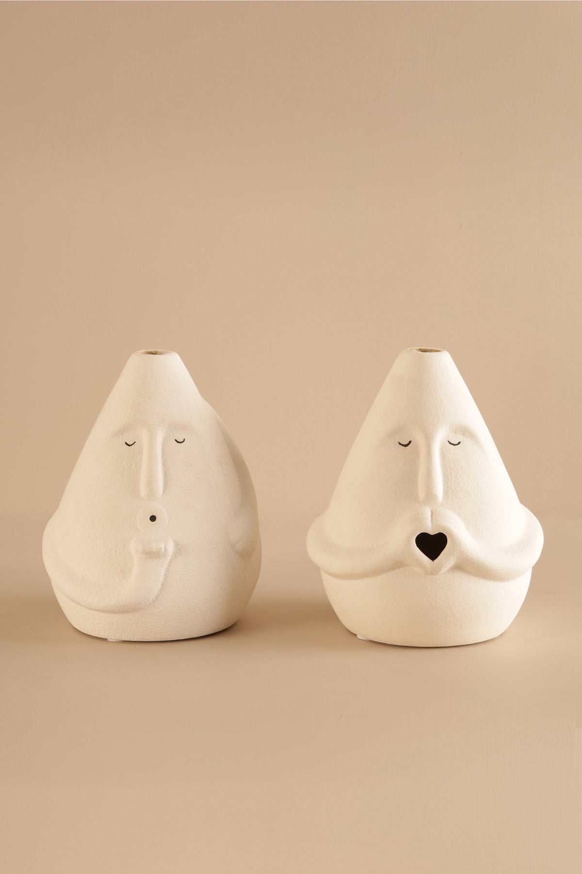 Minimalist ceramic face vase in off-white matte finish with heart-shaped mouth design