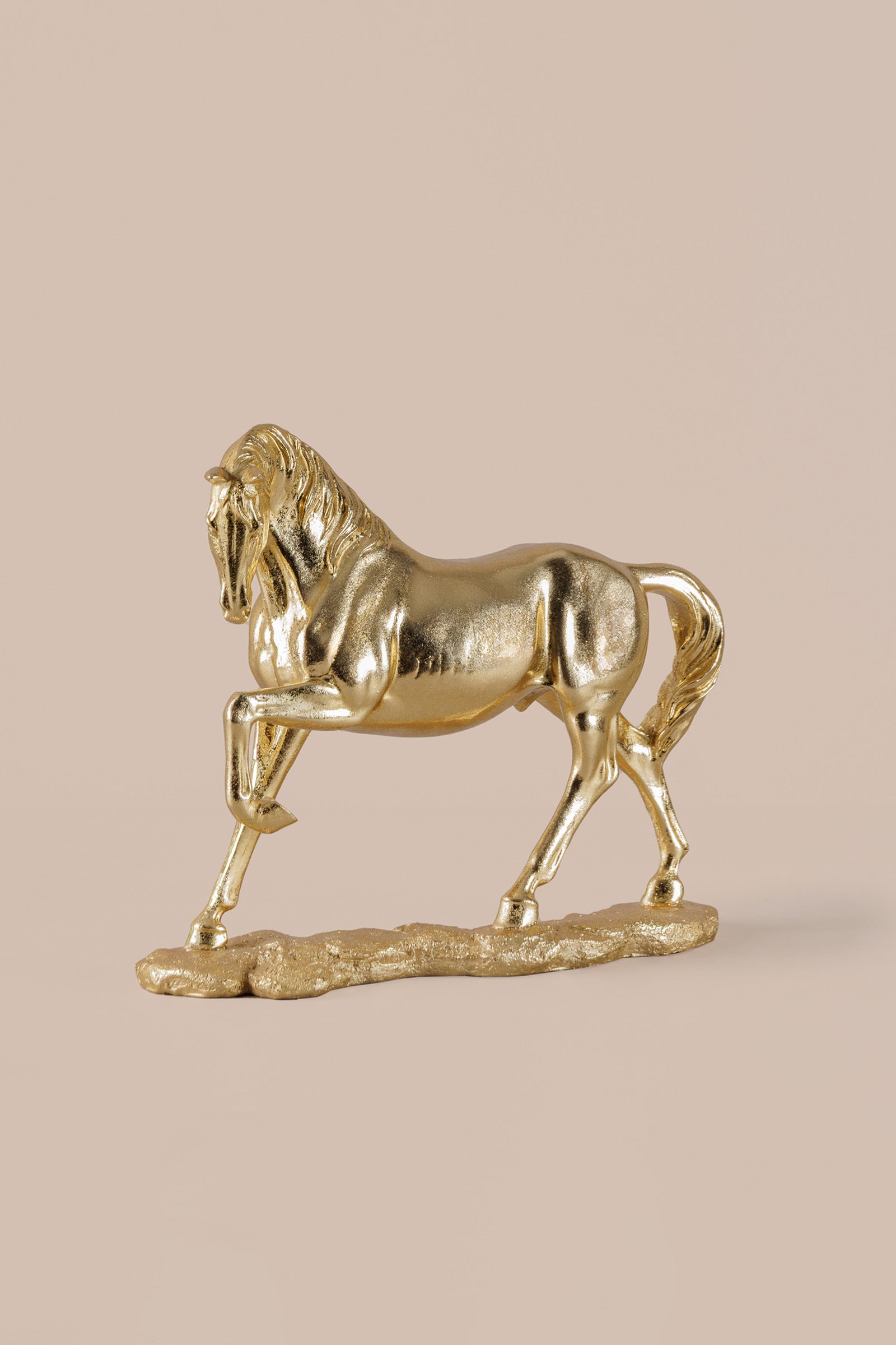 Close-up of gold horse sculpture showing detailed mane and sculpted form