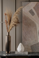 Minimalist ceramic face vase styled on shelf in contemporary interior setting