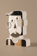 Ceramic sculpture showing smooth beige finish and reflective gold top