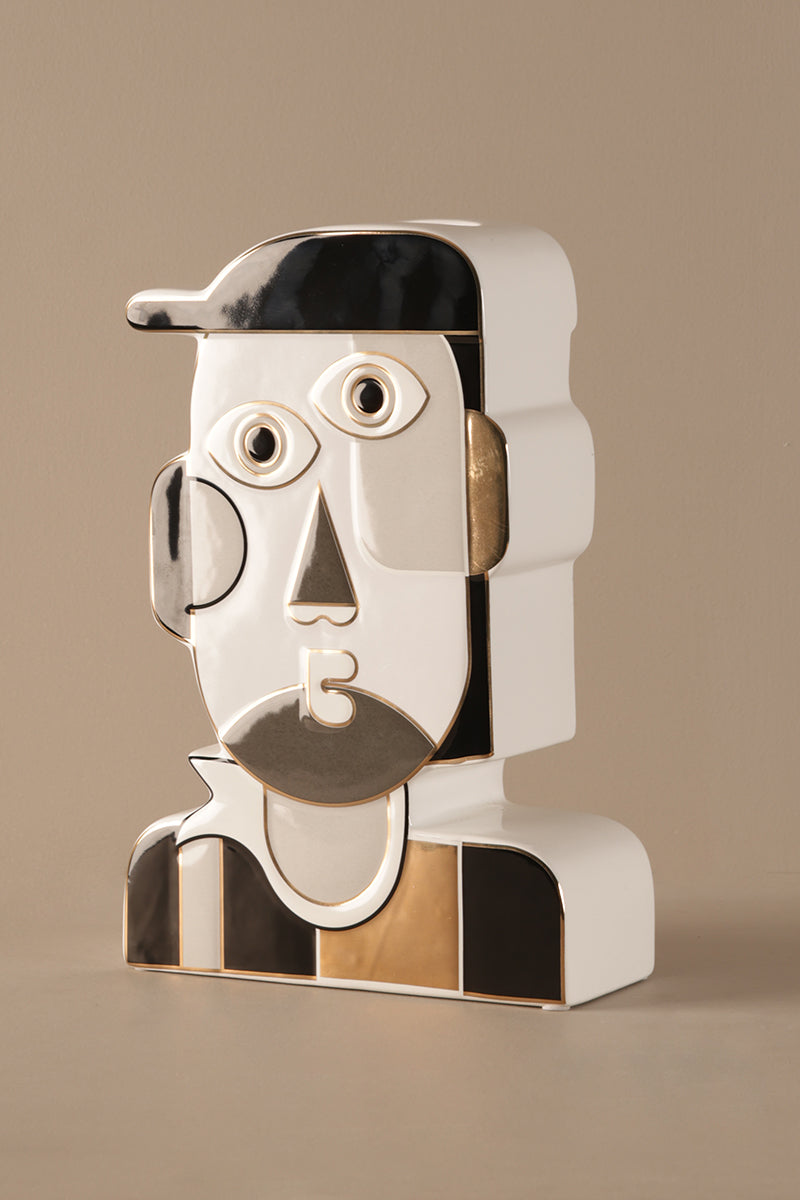 Ceramic sculpture showing smooth beige finish and reflective gold top