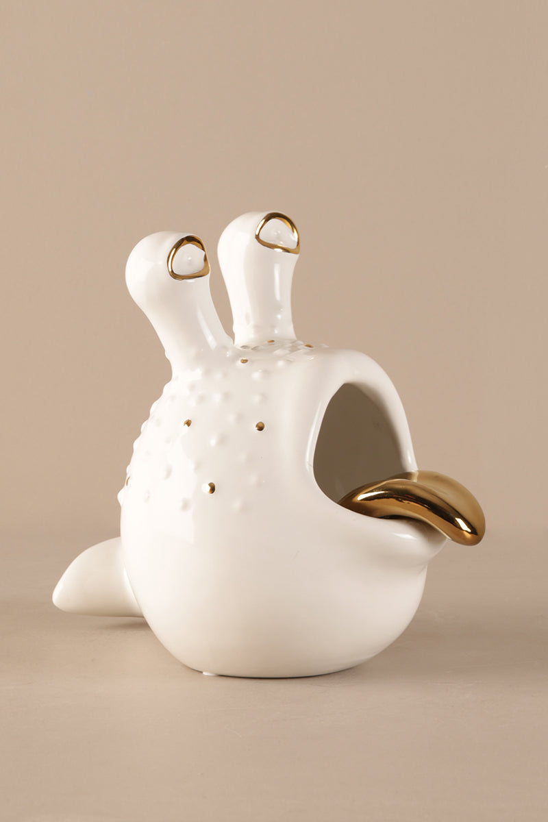 Contemporary porcelain decor piece with gold accent styled as a sculptural home accessory