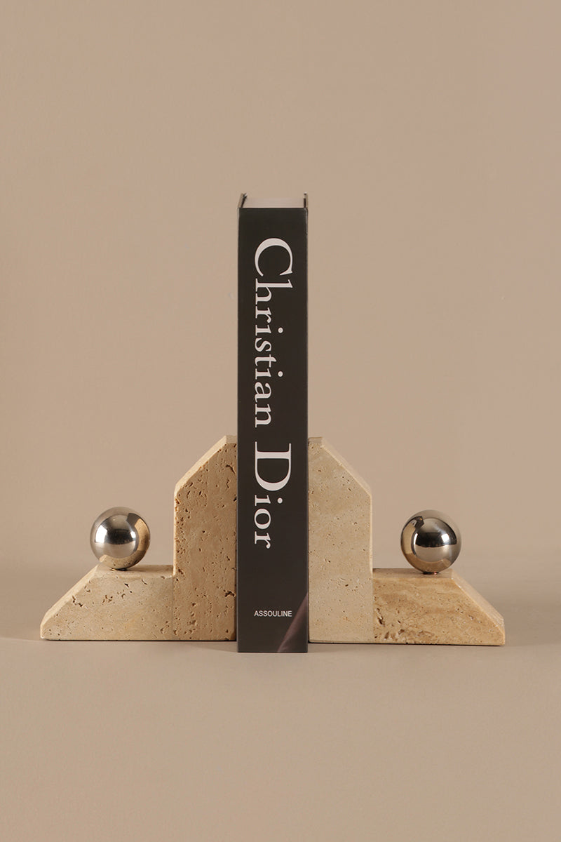 Christian Dior bookend with 'Assouline' branding on a beige background