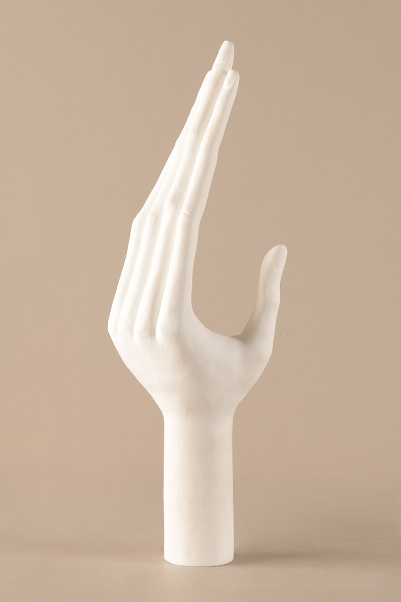 Ceramic hand sculpture showing smooth white glazed surface and refined detailing