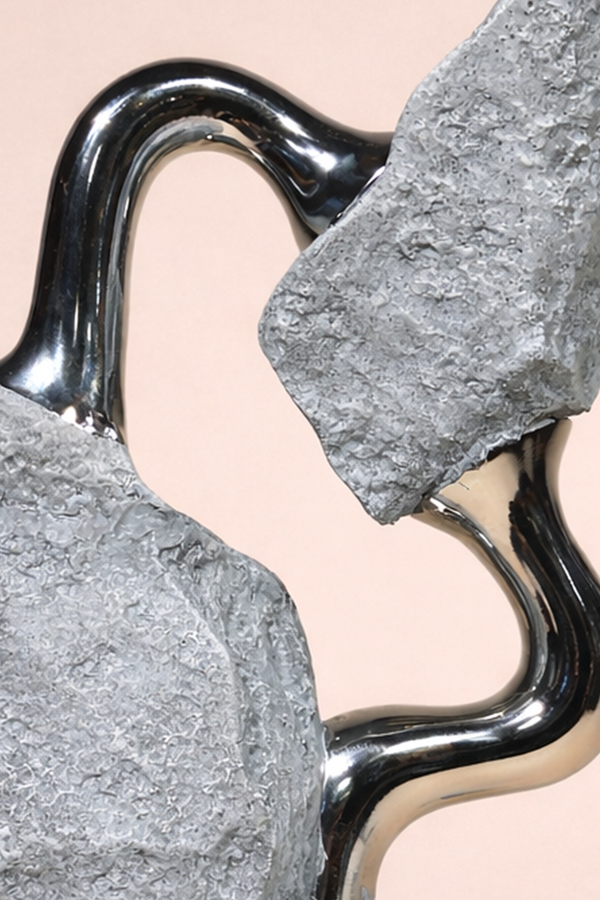 Close-up of a metallic hook with a stone texture on a beige background