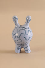 Modern ceramic creature sculpture with glossy blue finish and abstract detailing
