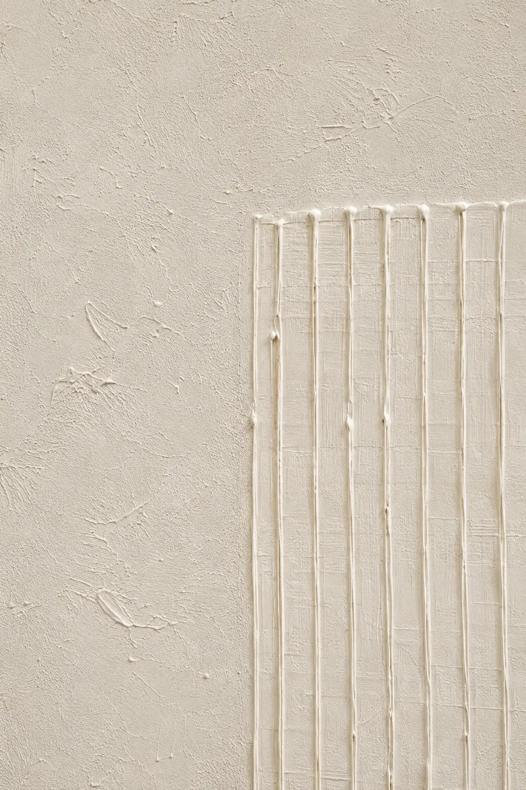 A close-up of a textured beige plaster or stucco wall with a rectangular section on the right featuring vertical ridges and subtle horizontal lines.