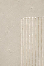 A close-up of a textured beige plaster or stucco wall with a rectangular section on the right featuring vertical ridges and subtle horizontal lines.