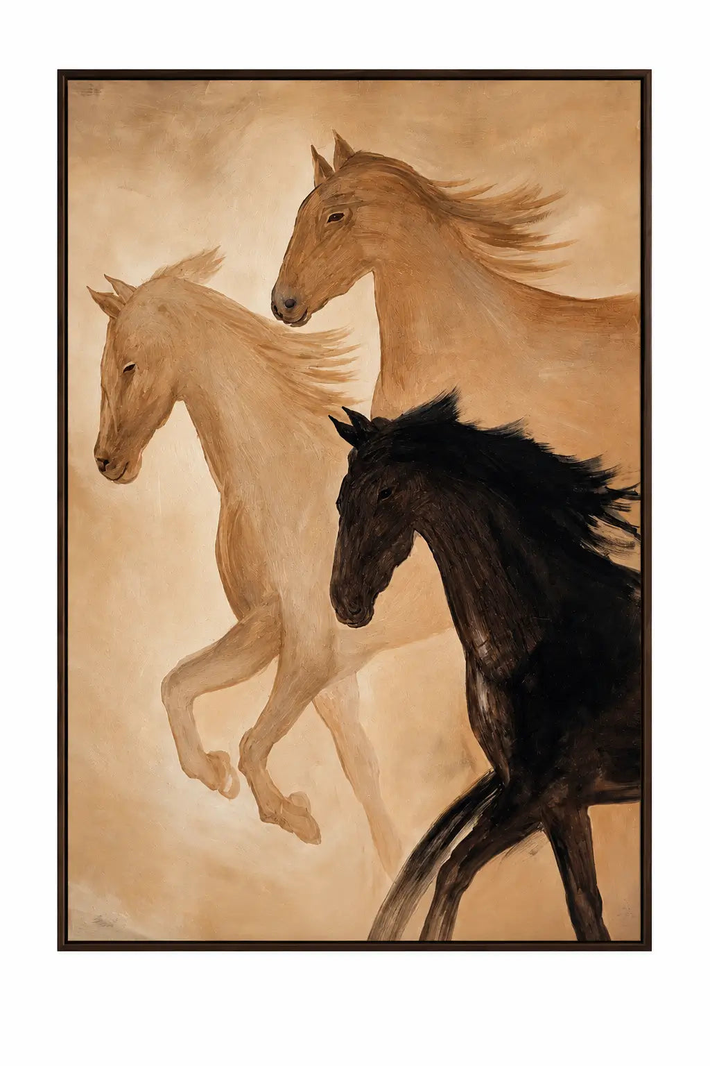 A framed art print depicting three horses in motion against a warm beige background. The horses are rendered in cream, tan, and black tones, and the piece is enclosed in a dark frame.