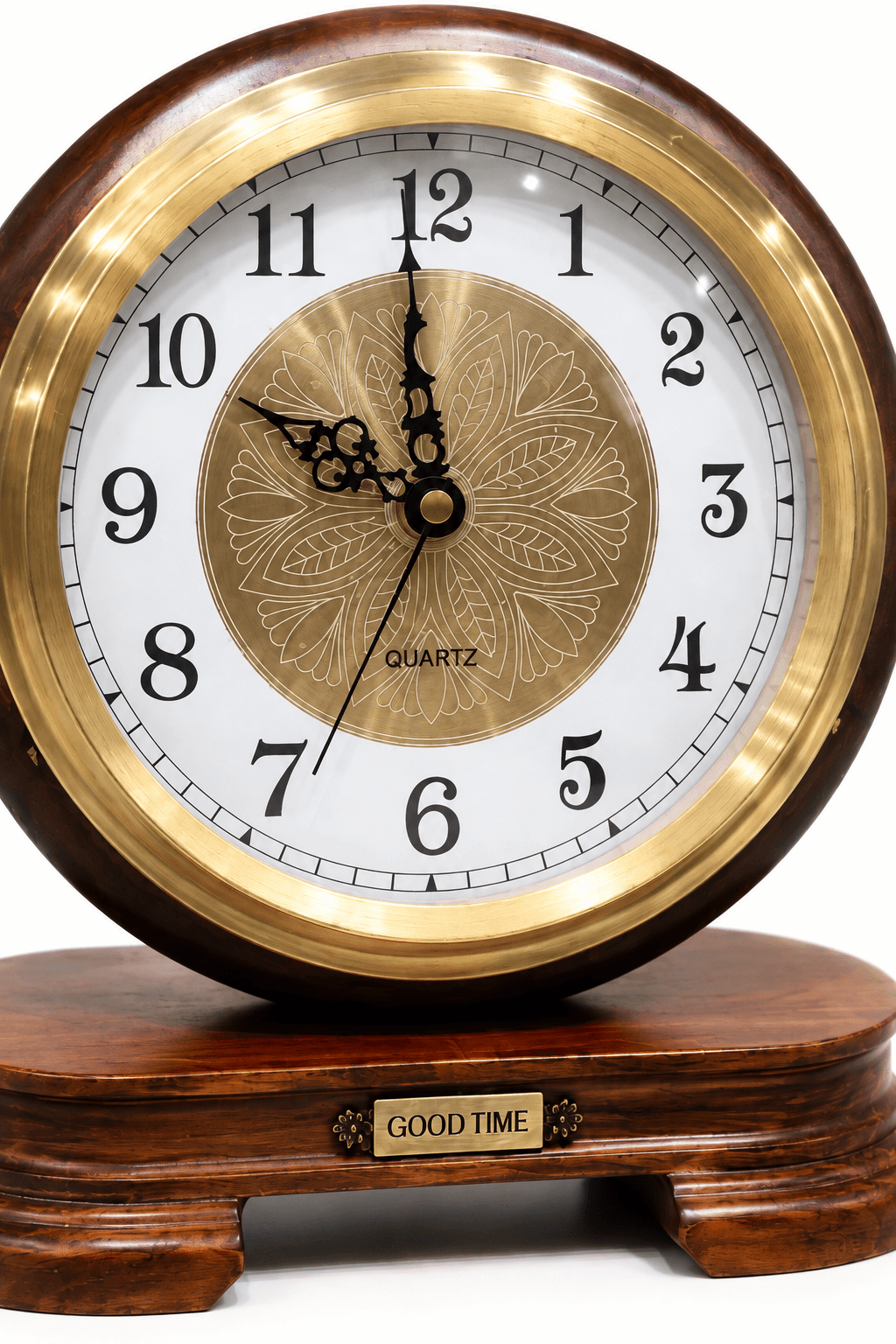 A round wooden desk clock with a polished gold-tone bezel, white dial, black numerals and hands, and a decorative gold medallion in the center. The clock sits on a dark wood base with a small gold plaque that reads 'GOOD TIME'.