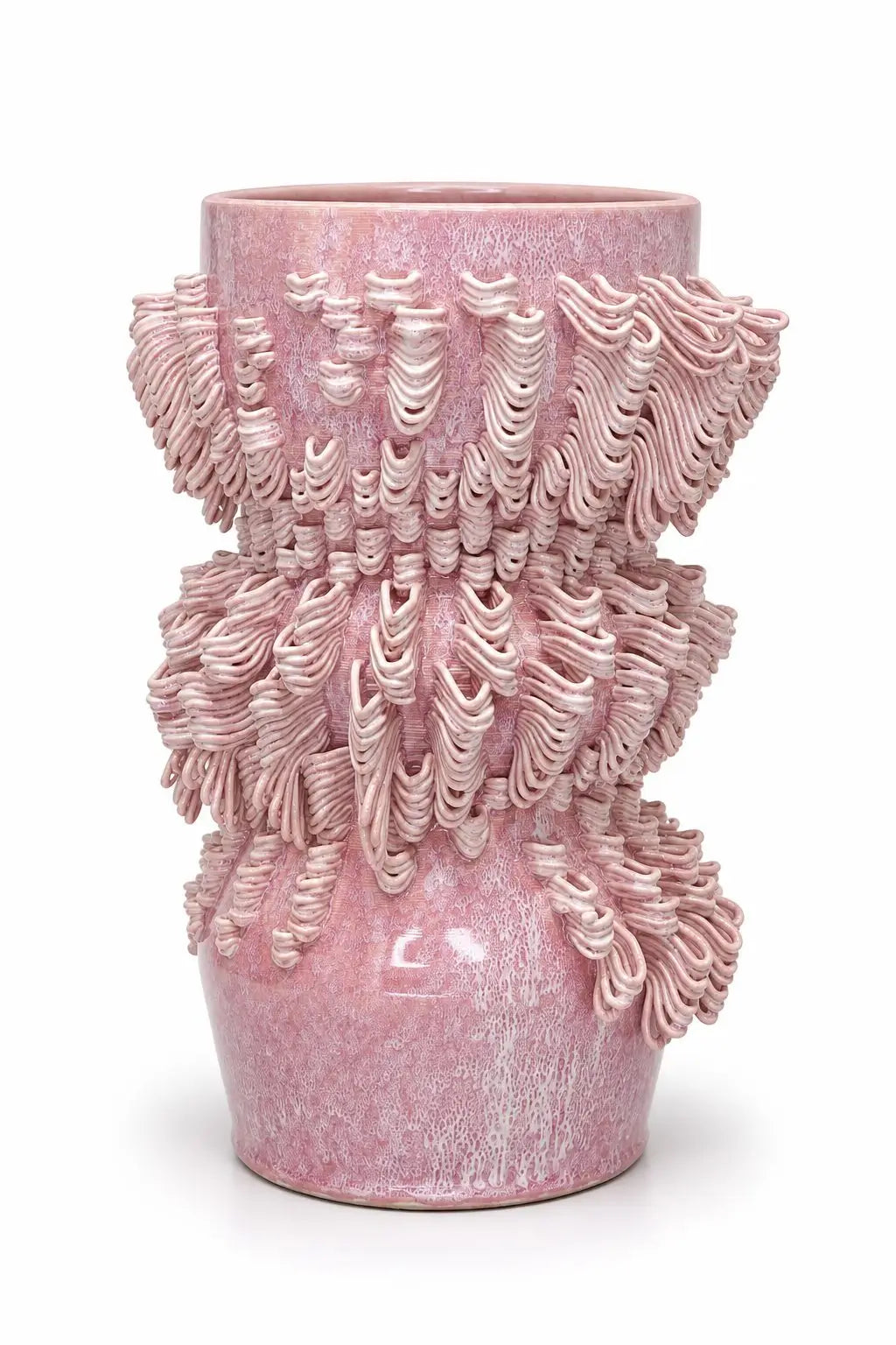 A pink textured ceramic vase with a flared rim and intricate, layered, sculpted ridges, shown on a plain white background.