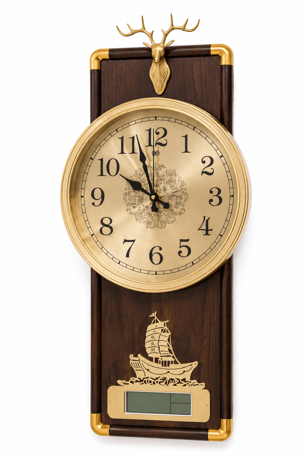 A decorative wall clock with a dark wood rectangular body, gold-tone metal trim, a round cream clock face with black numerals, a deer head topper, and a small ship illustration near a digital display window, shown on a white background.