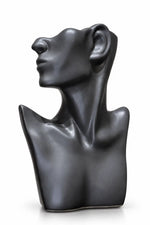 A dark charcoal gray ceramic sculpture of a stylized female bust in profile, shown on a clean white background.
