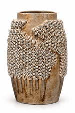 A rustic ceramic vase with a textured, ribbed brown and beige base, featuring a draped, chainmail-like metallic silver overlay on the upper half, set against a plain white background.