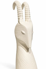 An off-white ceramic goat figurine with detailed ridges and curved horns, shown against a plain white background.
