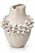 A beige ceramic vase with a textured glaze and a decorative band of sculpted flower petals around the upper half, shown on a white background.