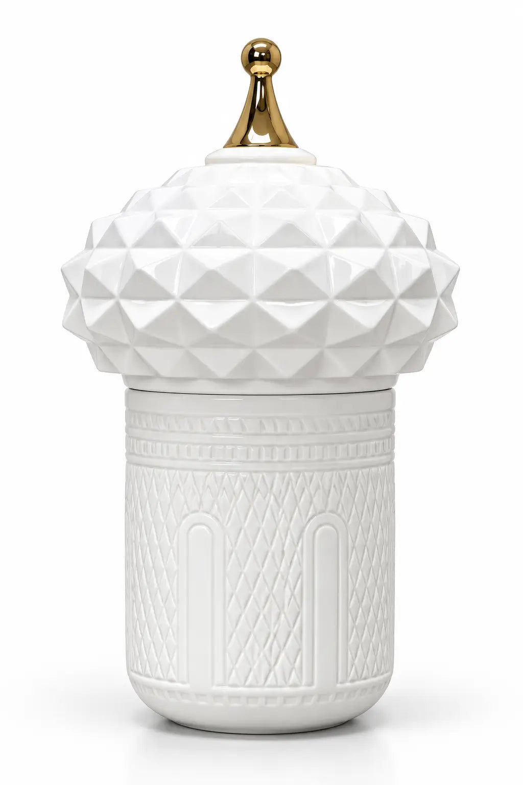 A white ceramic lidded container with a faceted, geometric textured lid and a small gold finial on top, set against a plain white background.