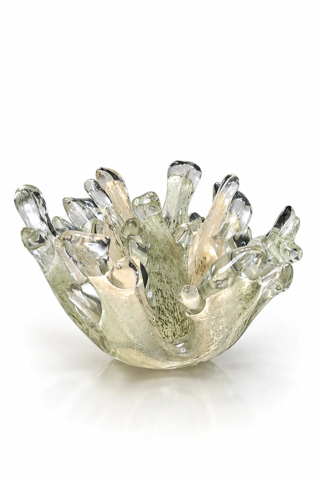 A sculptural, hand-blown glass bowl with a flared, coral-like rim, featuring a translucent iridescent finish with green, gold, and gray tones, set against a plain white background.