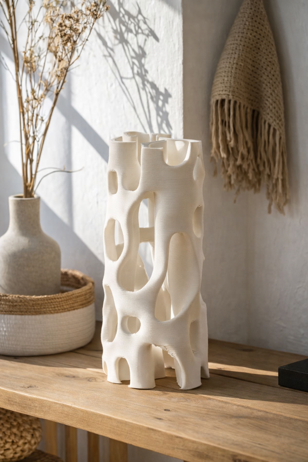 White textured vase on a wooden surface with a neutral background