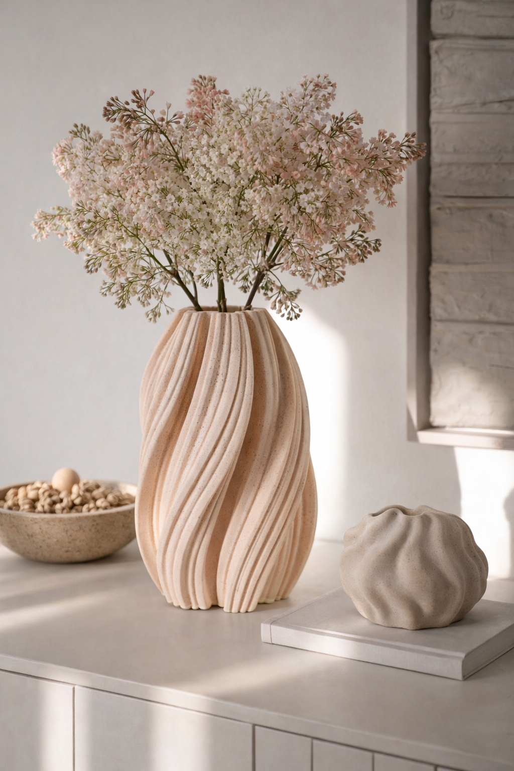 Decorative vase with flowers on a table against a neutral wall