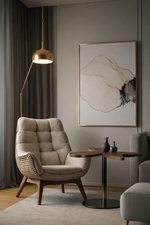 Modern living room with a beige armchair, side table, and abstract art on the wall.