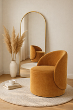 Mustard yellow chair in a room with a mirror and decorative elements.