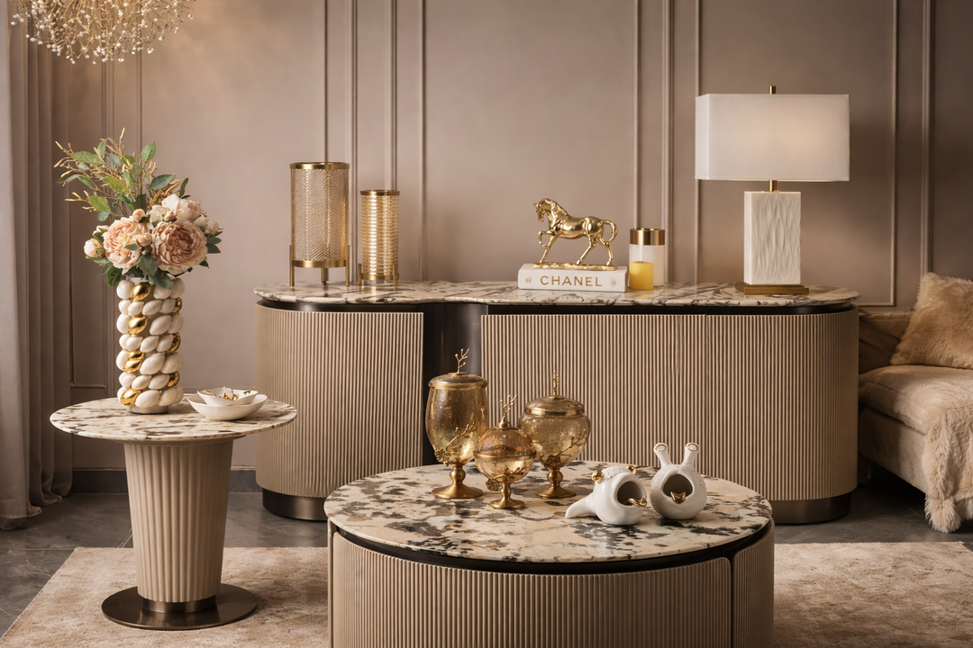 Luxurious interior with marble tables, decorative items, and a Chanel logo.