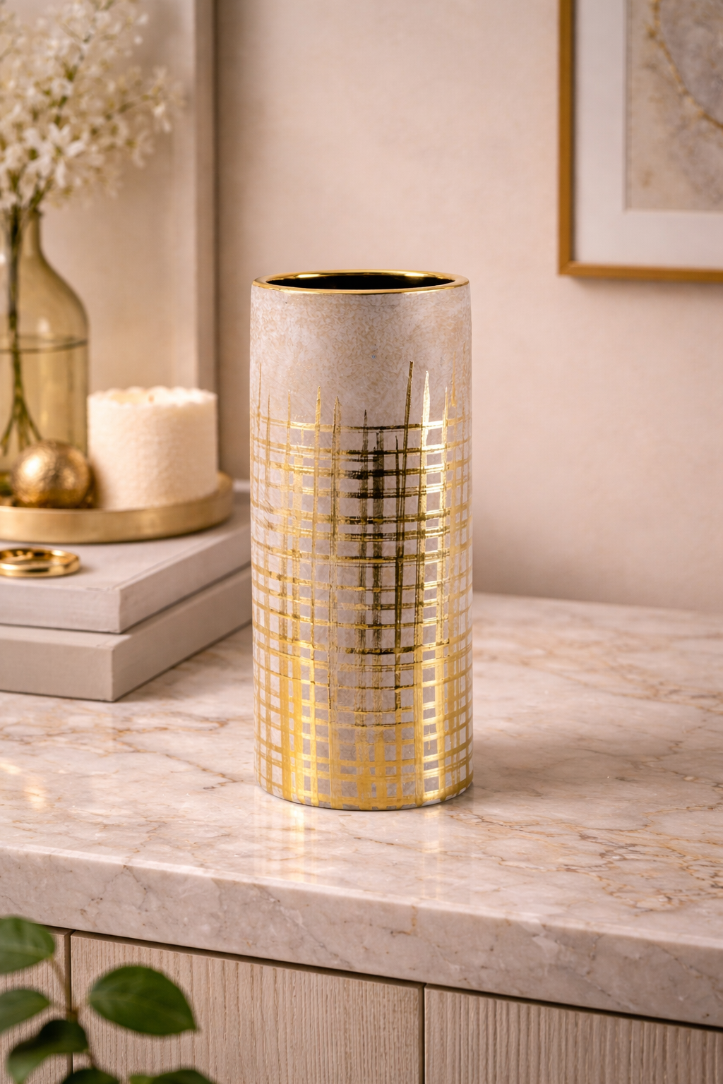 Decorative vase with gold patterns on a marble surface
