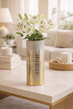 Decorative vase with flowers on a coffee table in a living room setting